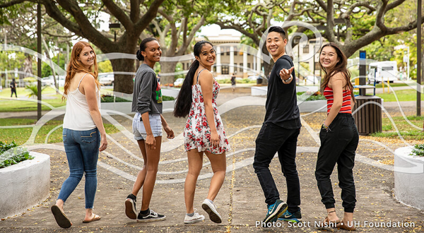 Five UH students walking towards Hawaii Hall